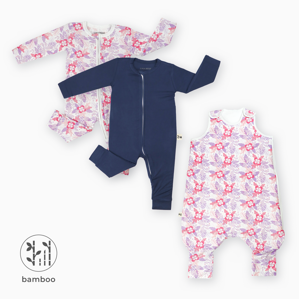 2 LiaaBébé Sleepsuits without feet. One in navy blue and one with purple flower. 1 LiaaBébé Purple Flower Sleeping Bag with feet.