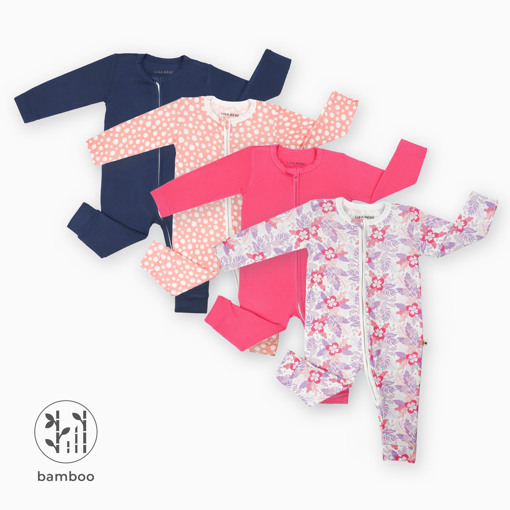 Pack of 4 LiaaBébé Sleepsuits in navy blue, hot pink, purple flower and light pink with dots without feet.