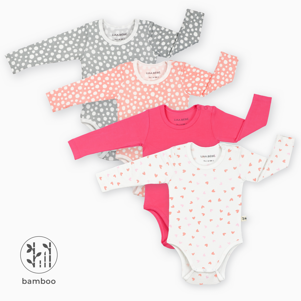 Pack of 4 LiaaBébé Long Sleeve Bodysuits in hot pink, pink hearts, light grey and light pink with dots.
